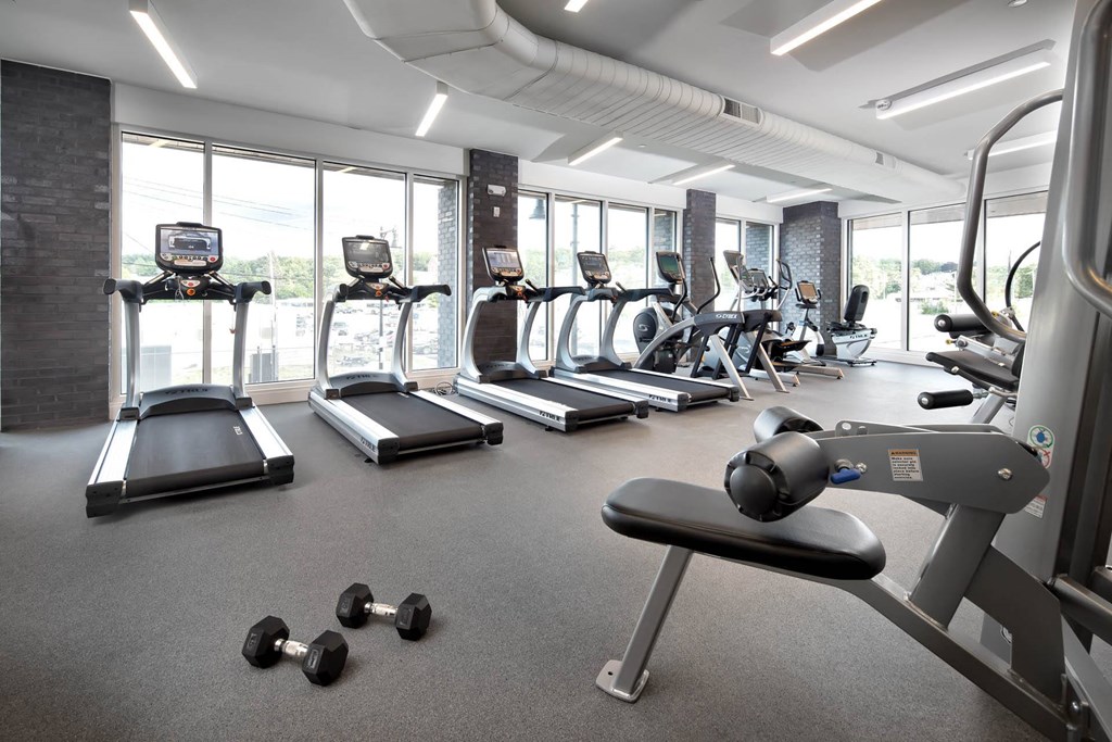 a gym with treadmills and other exercise equipment