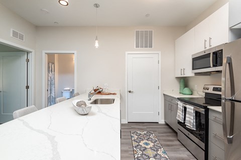 a kitchen with stainless steel appliances and a white counter top