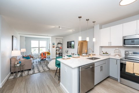 a kitchen with an island and a living room with a couch