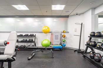 a fitness room with weights and other exercise equipment - Photo Gallery 7