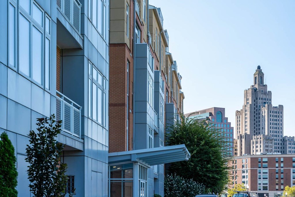 a city street with a tall building in the background