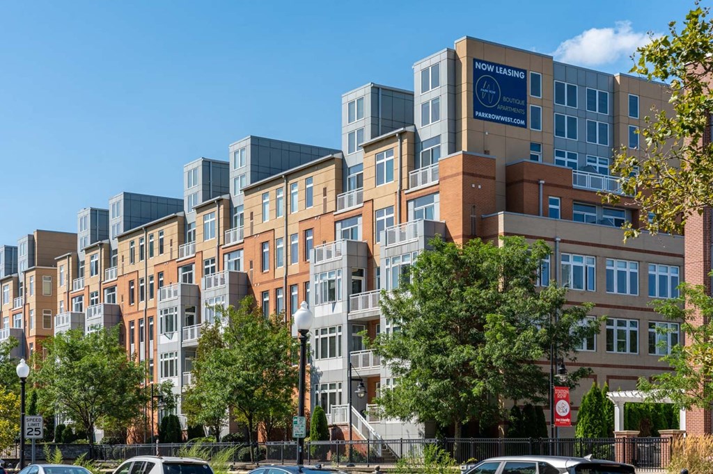picture of a building with many windows and trees in front of it