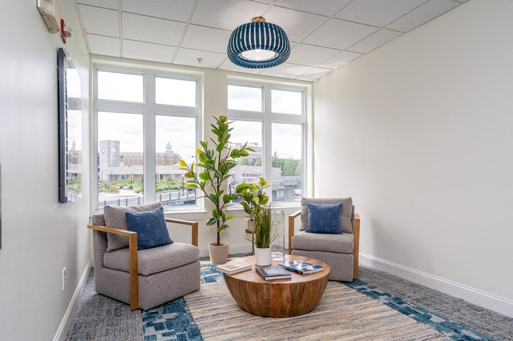 a lounge area with two chairs and a coffee table