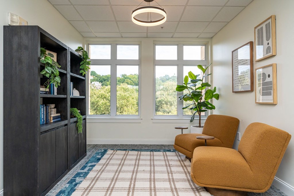 a seating area with a couch and a chair in front of a window