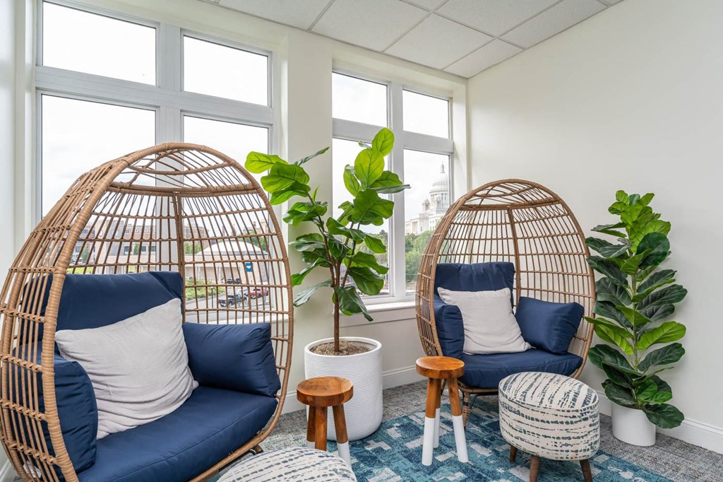 a room filled with furniture and a large window