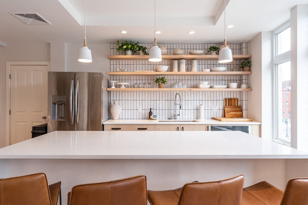 community entertaining kitchen with open shelving and a large white island