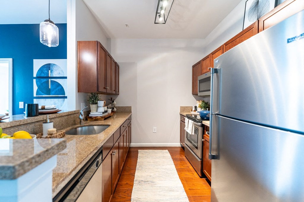 a kitchen with wood cabinets and granite countertops