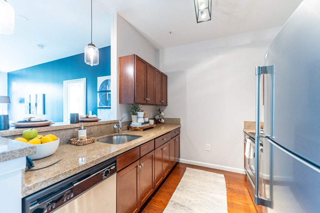 a kitchen with wood cabinets and granite countertops