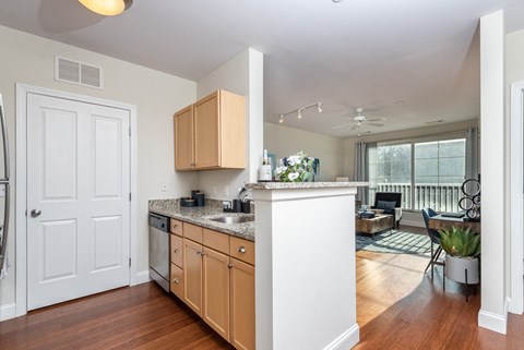A kitchen with wooden cabinets and a white island.