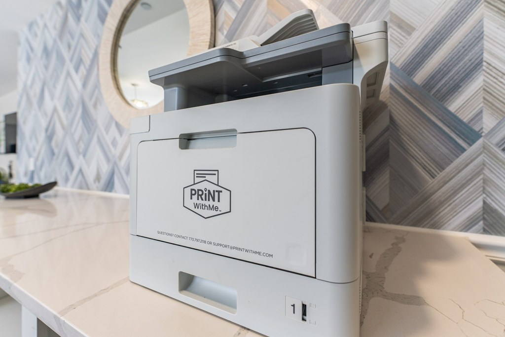 A white and black printer with the words "Print With Me" on it.