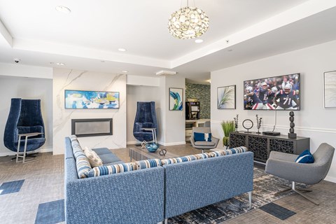 A living room with a blue sofa and a fireplace.