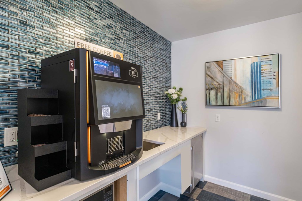 Sip With Me coffee machine with a digital display is on a counter.