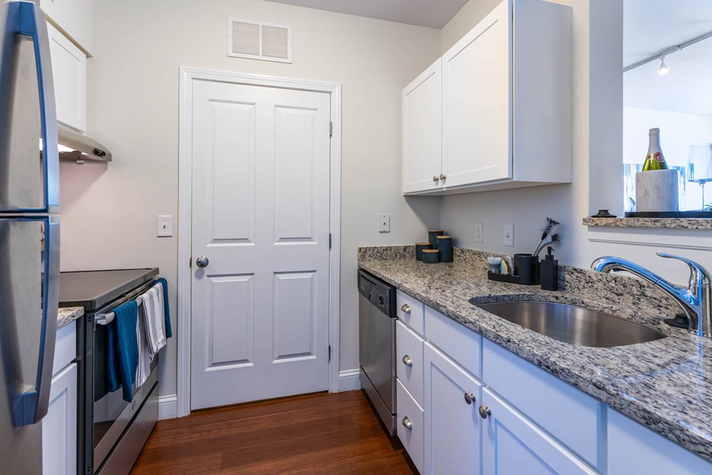 Parkside Commons kitchen with a white cabinetry and a stainless steel refrigerator.