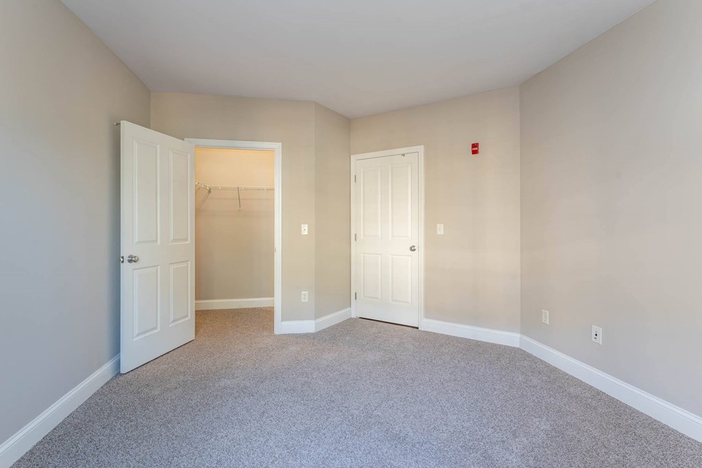 Chelsea Place vacant apartments room with two doors and a carpeted floor.