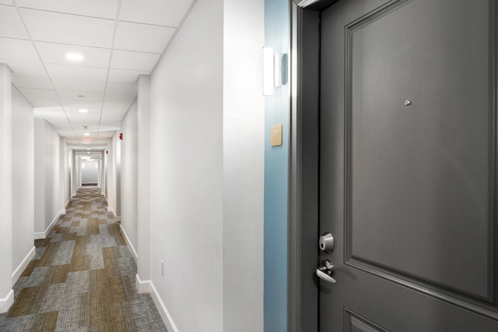 Parkside Commons hallway with a blue door and a carpeted floor.