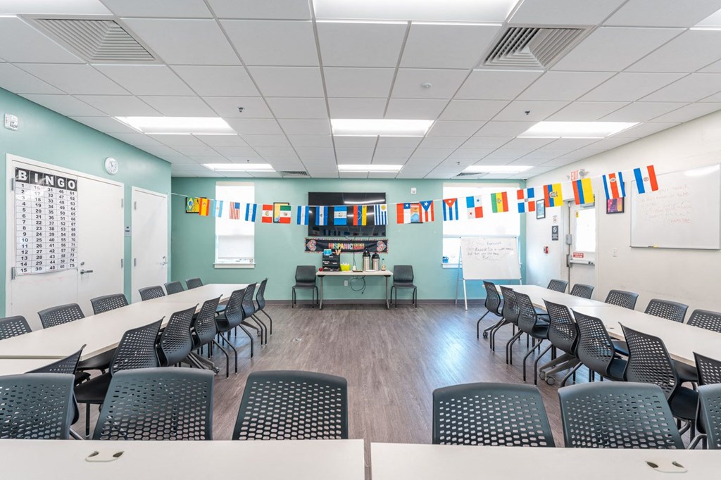 Pelham lifelong learning center tables and seating with tv and decorations