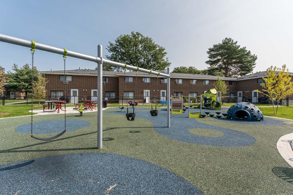 playground with swings and rubber matt underneath