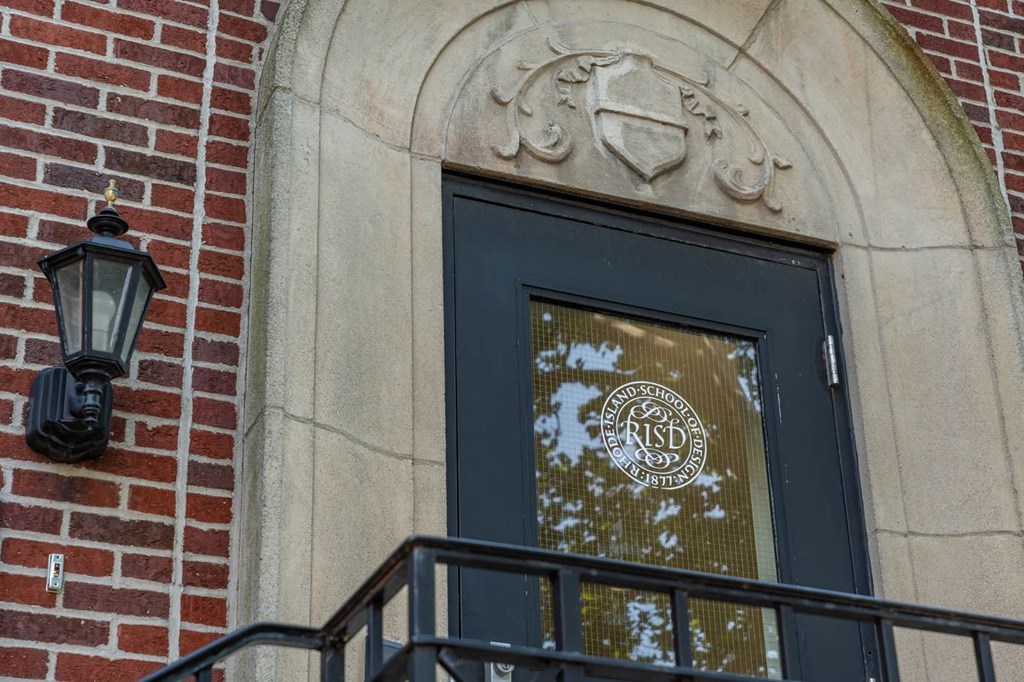 A black door with a glass window and a metal railing Rhode Island School of Design