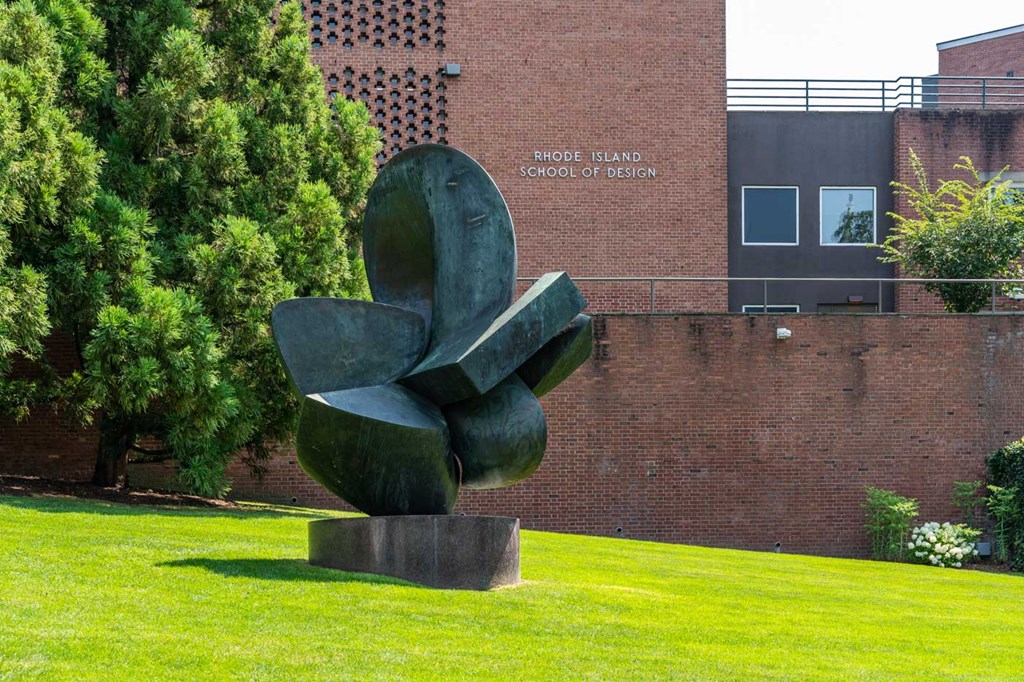 A large sculpture sits on a pedestal in front of the Rhode Island School of Design.