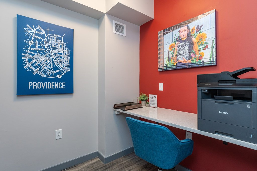 A blue chair sits in front of a Providence map on a wall.