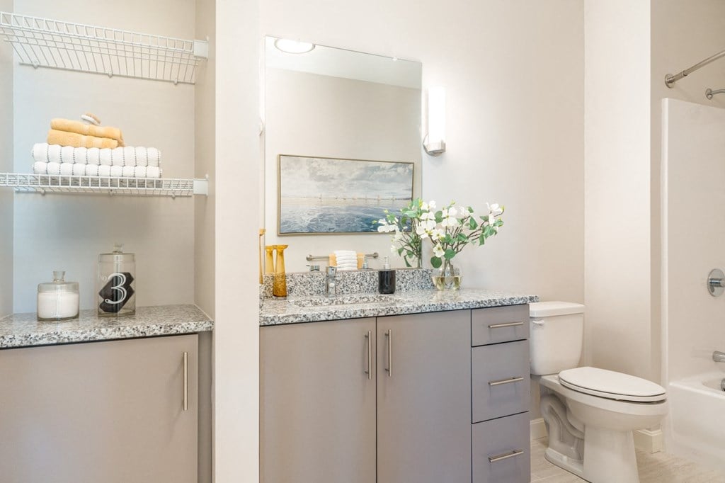 redbrook model apartment bathroom with cabinets and bright lighting
