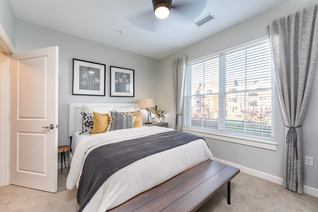 model bedroom with plush carpeting and ceiling fan
