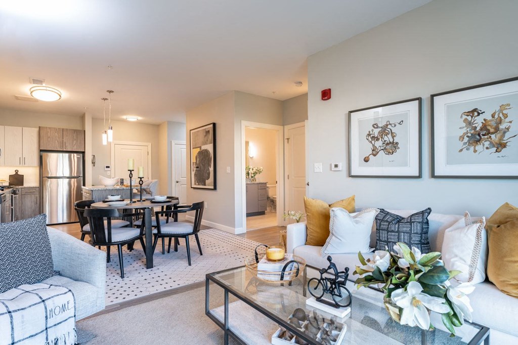 Large living space with dinner table and carpeted floor