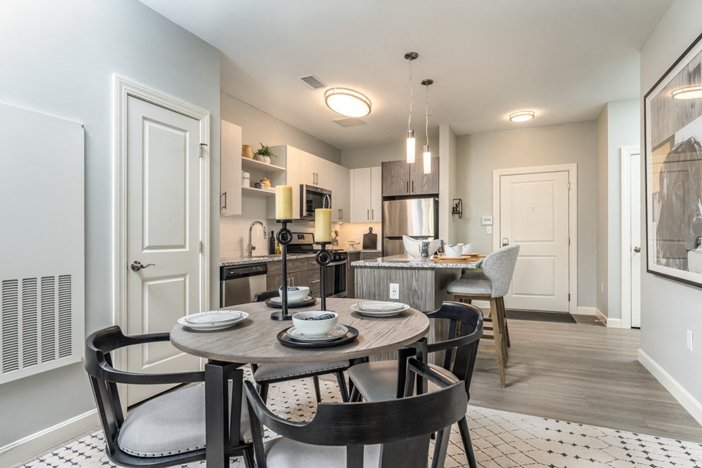 Large living space with dinner table and carpeted floor