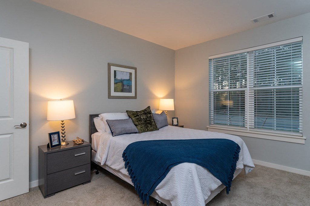 Two bedroom model apartment bedroom with plush carpeting