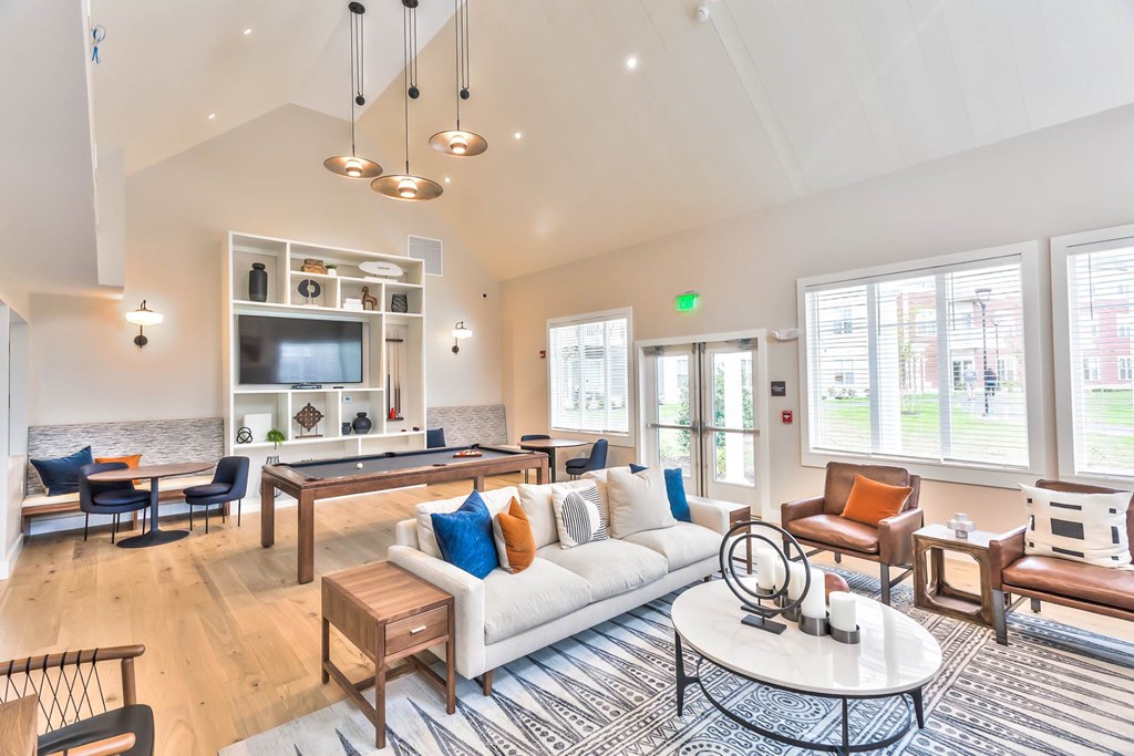 A living room with a white couch and a coffee table.