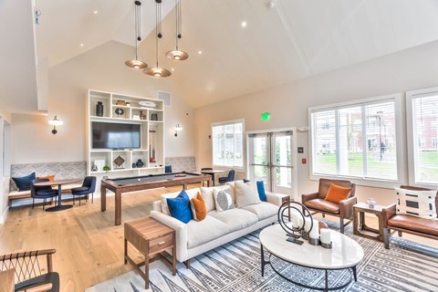 A living room with a white couch and a coffee table.