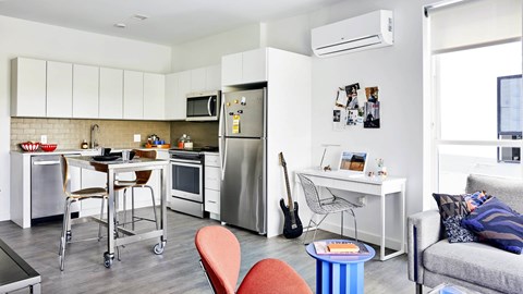 A modern kitchen with a dining table and chairs.