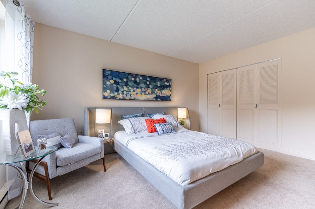 a bedroom with a bed and a chair