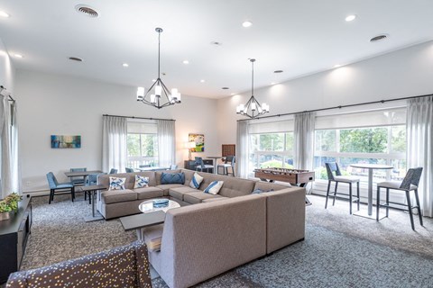 a living room with a couch and a table with chairs