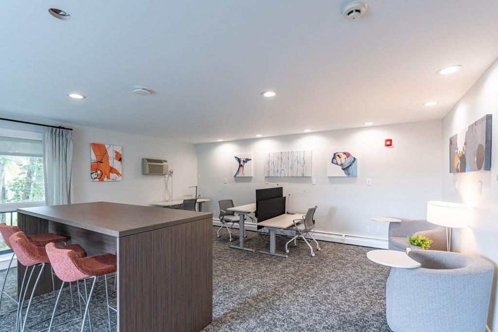 a living room with a table and chairs and a desk