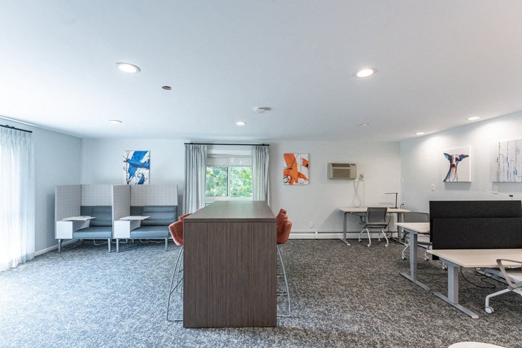 a conference room with a desk and chairs and a tv
