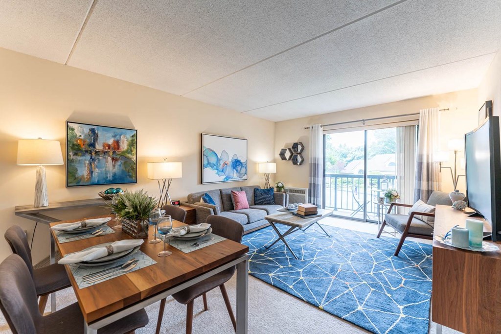 a living room and dining room with a couch and a table