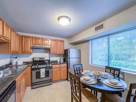 a kitchen and dining room with a table and chairs