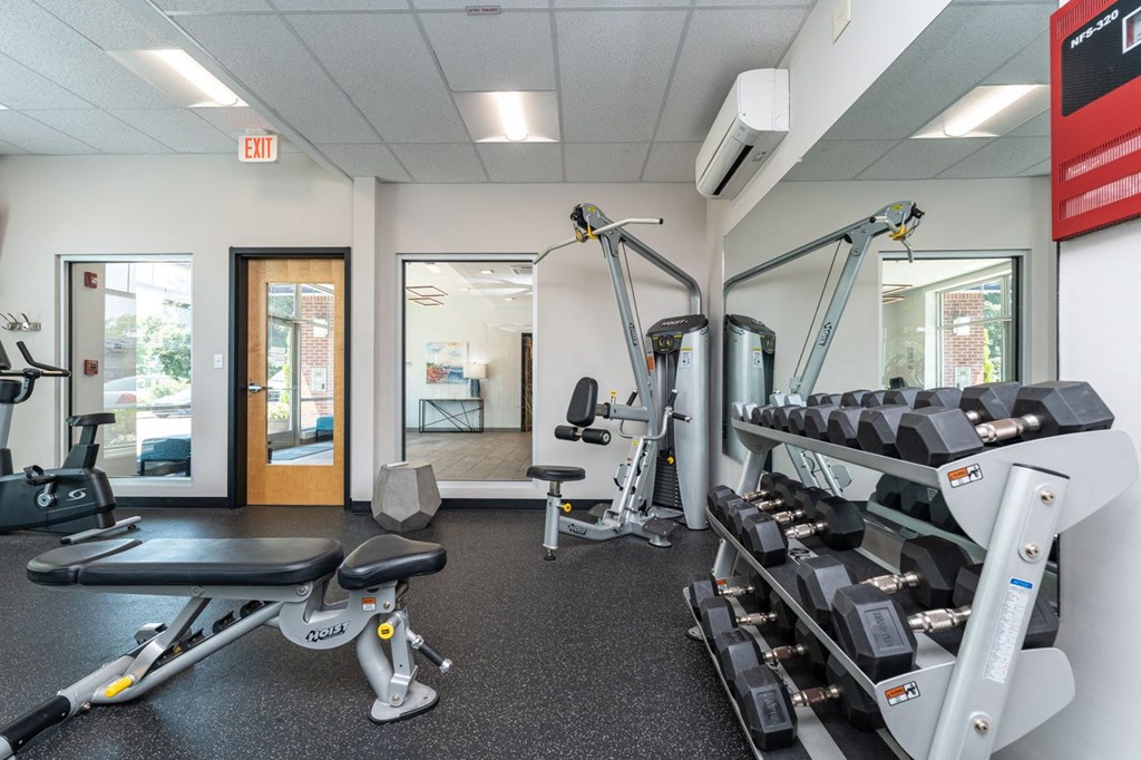 a gym with cardio equipment and weights at one mansfield ave
