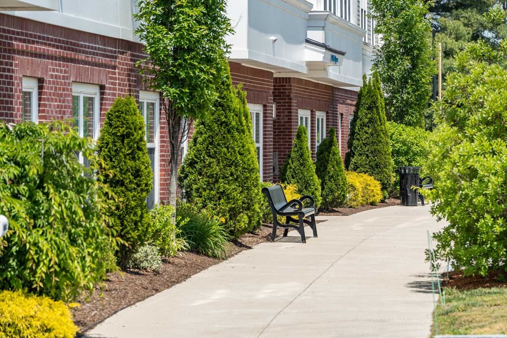 a bench on a sidewalk in front of a building