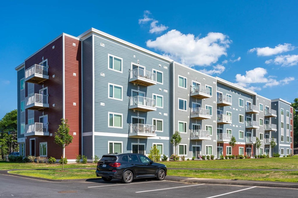 a car parked in front of an apartment building
