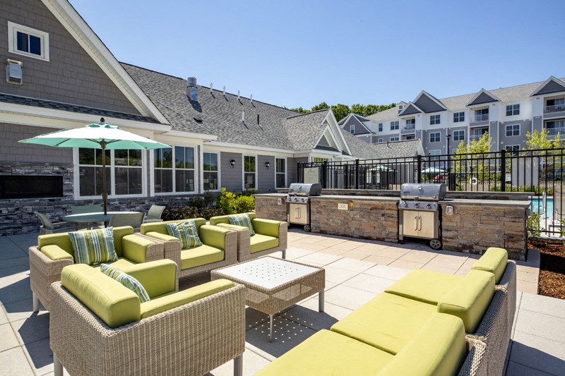 outdoor furniture overlooking pool deck & grills