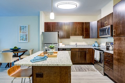 a kitchen with wooden cabinets and a granite counter top