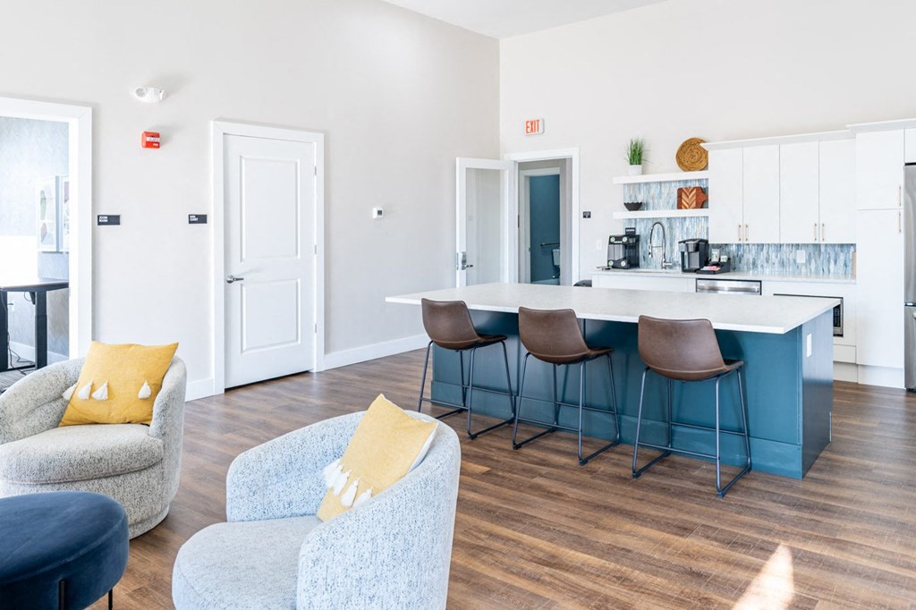 a picture of the club house at the sto in stoughton with a kitchen island and seating