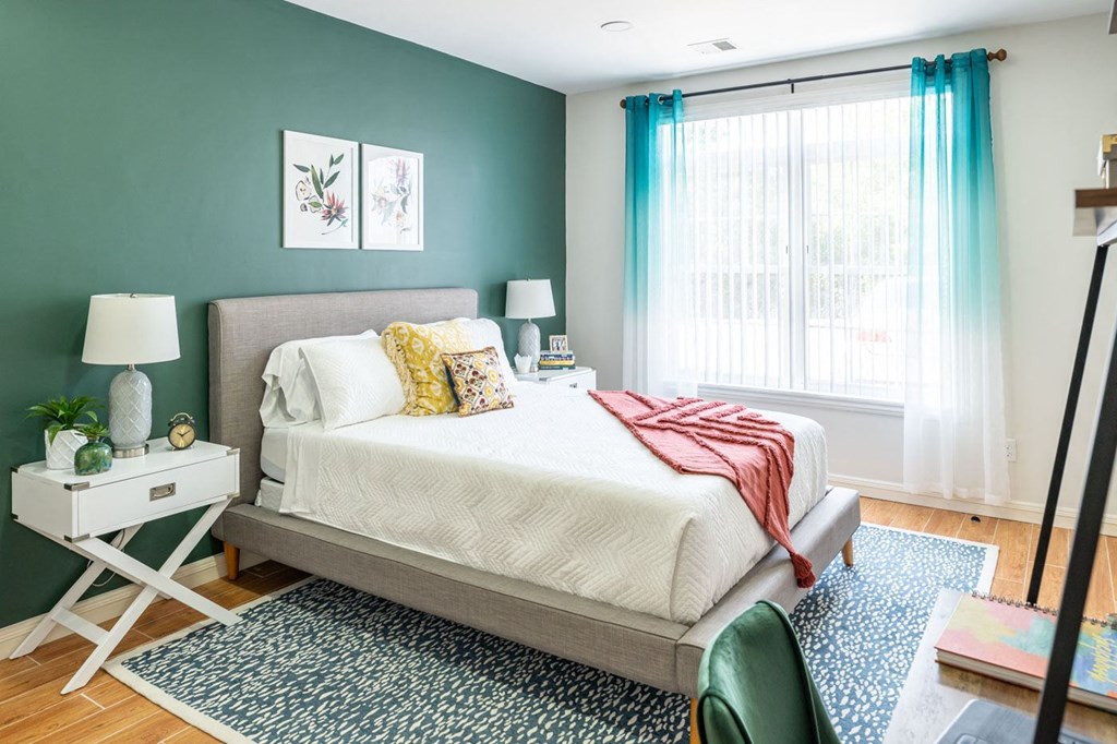 The Sto one bedroom apartment with wide plank flooring, open windows and bright ceiling light fixtures