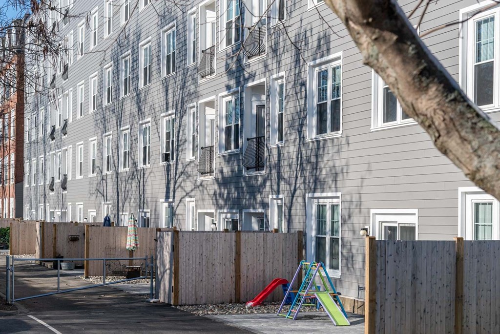 an empty playground in front of an apartment building