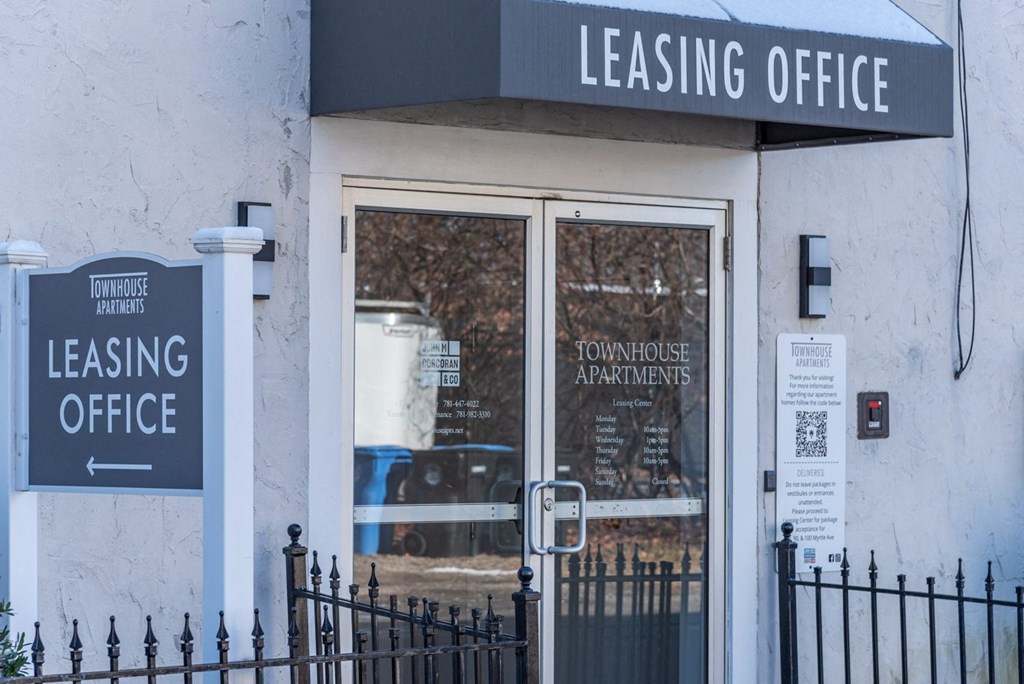 the outside of a leasing office with a gate