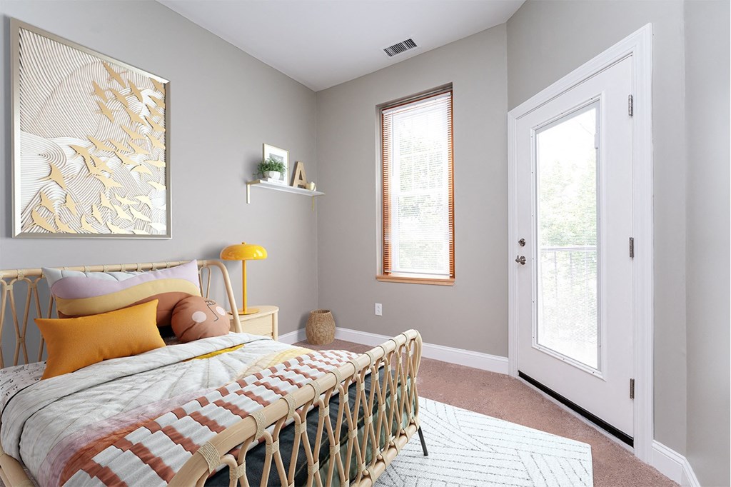 Bedroom with balcony door at Townhouse Apartments in Whitman