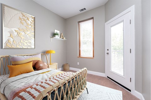 a bedroom with a bed and a white door