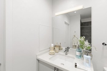 a bathroom with a sink and a mirror - Photo Gallery 8